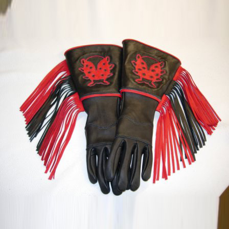 A pair of gloves with red and black tassels.